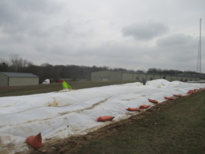 Figure 2. Covering a strawberry field with a row cover.