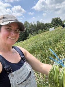 Ann with garlic scapes (May 2024). 