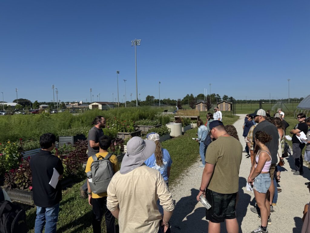 Small Farm Education field day attendees listen to Chris Adair talk about flower production in raised beds.