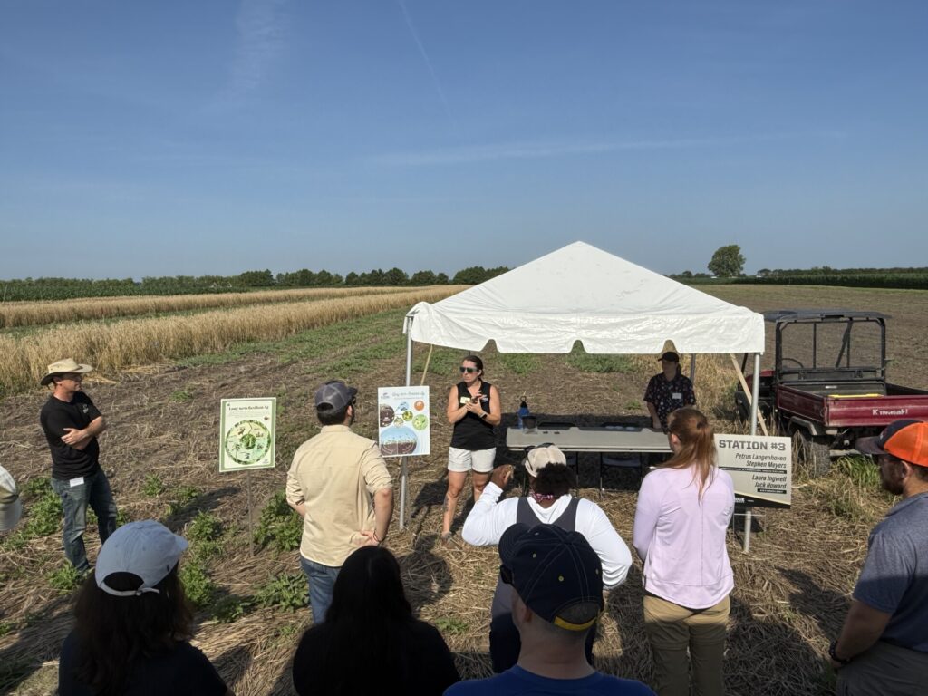 Attendees at the Fruit and Vegetable field day listen to Steve Meyers and Laura Ingwell talk about the long-term resilient agriculture research at Meigs.